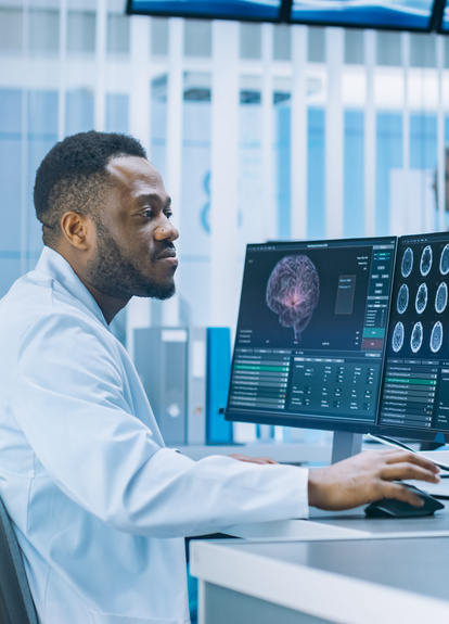 Medical Professional Analyzing Brain Scans on Monitors in a Modern Laboratory