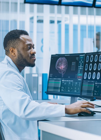 Medical Professional Analyzing Brain Scans on Monitors in a Modern Laboratory