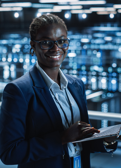 IT Professional Working on a Laptop in a Data Center